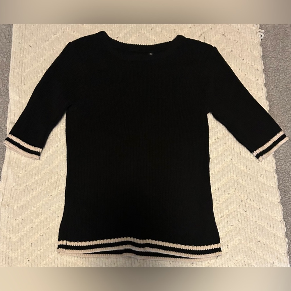 Black And White Tight Fitting Shirt. Sleeves Go Down To About The Elbows.